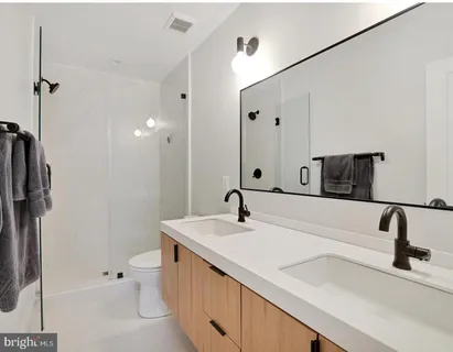 a bathroom with a tub sink toilet and mirror