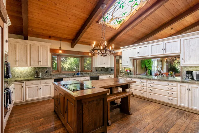 a kitchen with stainless steel appliances granite countertop a sink stove and cabinets
