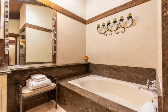 a bathroom with a bathtub and a window