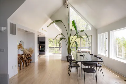 a view of a dining room with furniture window and wooden floor