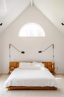 a bedroom with a bed and a mirror