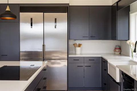 a kitchen with a refrigerator a sink and cabinets