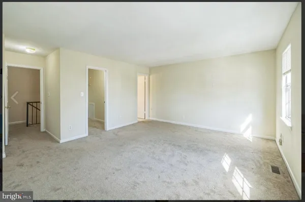 a view of an empty room and a window