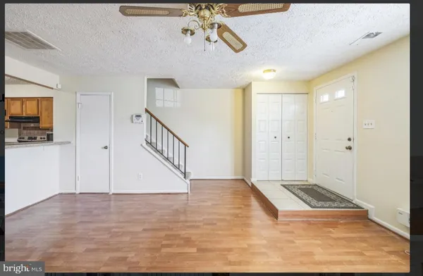 a view of an entryway with wooden floor