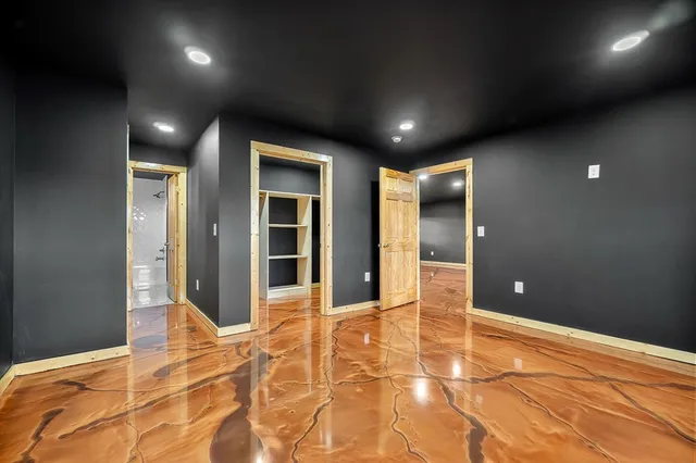 a bedroom with a large bed and a large window