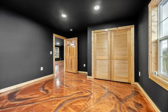 a bathroom with a granite countertop double vanity sink and a mirror