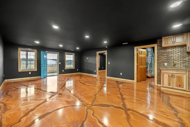 a kitchen with granite countertop a refrigerator and a stove top oven