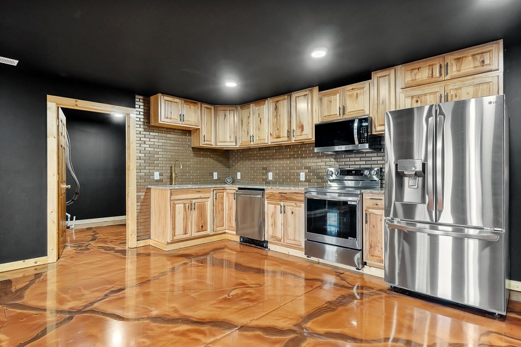 120 Joshua Road Cookeville, TN 38501 - Photo 8 of 21 a kitchen with granite countertop a refrigerator and a stove top oven