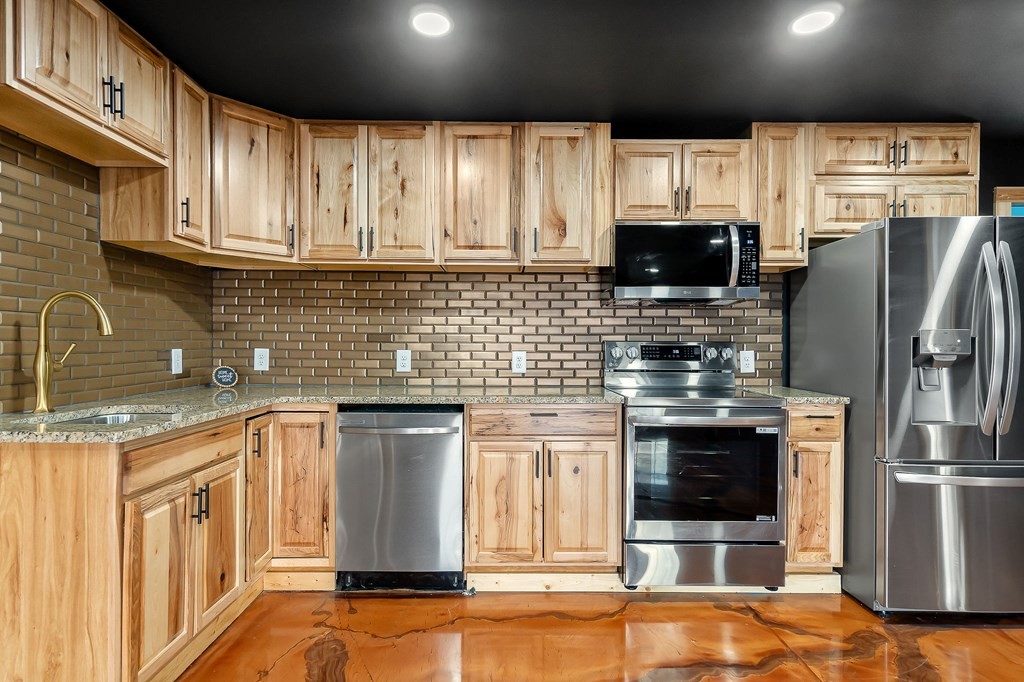 120 Joshua Road Cookeville, TN 38501 - Photo 9 of 21 a kitchen with stainless steel appliances granite countertop a stove a sink and a microwave