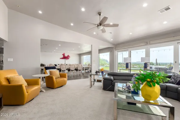 a living room filled with furniture and a large window
