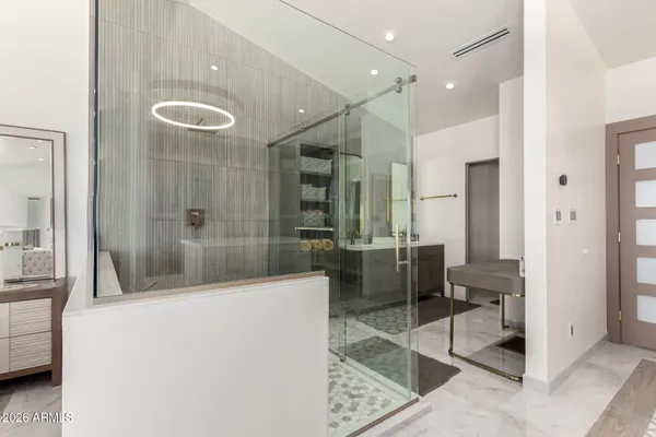 a bathroom with a tub a mirror and a shower