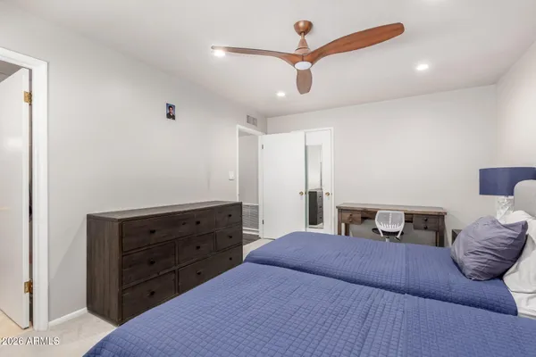 a bedroom with a large bed and a window