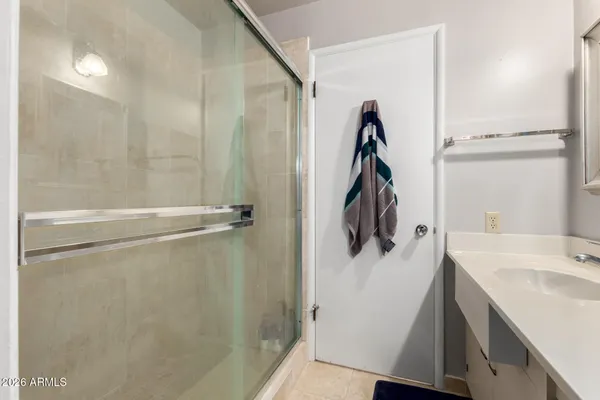 a bathroom with a sink vanity and mirror