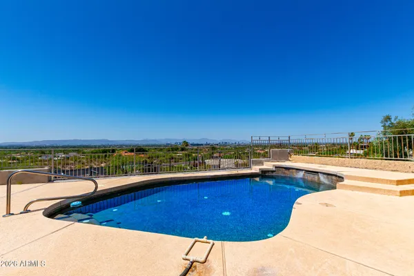 a view of a swimming pool and a lounge chair