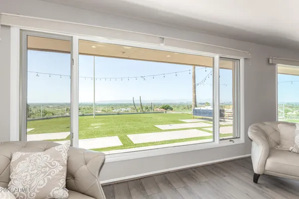 a living room with a large window and a bed