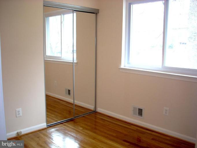 8715 Clydesdale Road Springfield, VA 22151 - Photo 13 of 19 an empty room with wooden floor and windows