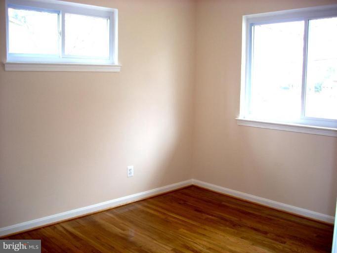8715 Clydesdale Road Springfield, VA 22151 - Photo 14 of 19 an empty room with wooden floor and windows
