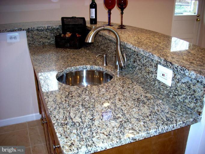 8715 Clydesdale Road Springfield, VA 22151 - Photo 17 of 19 a kitchen with a granite countertop sink