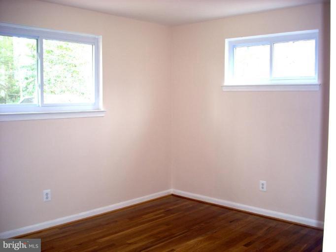 8715 Clydesdale Road Springfield, VA 22151 - Photo 7 of 19 an empty room with wooden floor and windows