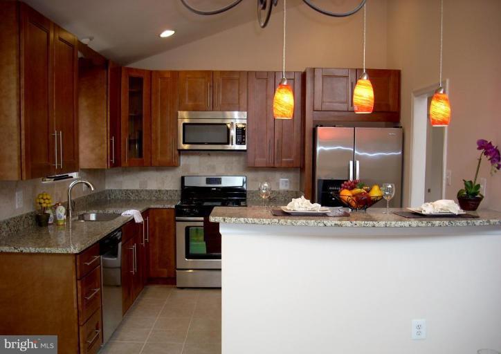 8715 Clydesdale Road Springfield, VA 22151 - Photo 10 of 19 a kitchen with a sink cabinets and stainless steel appliances