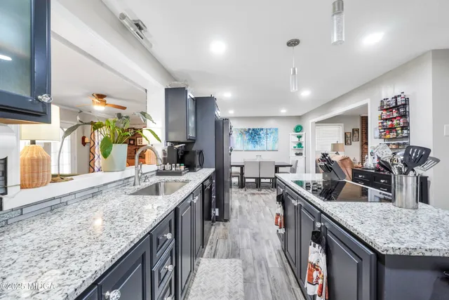 a kitchen with counter top space a sink stainless steel appliances and cabinets