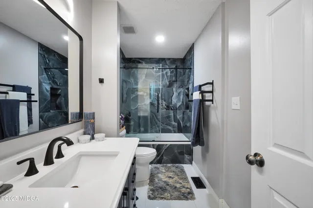 a bathroom with a sink toilet and shower