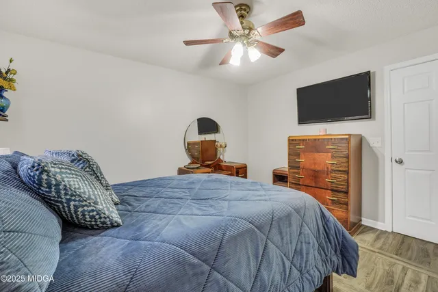 a bedroom with a bed and a flat screen tv