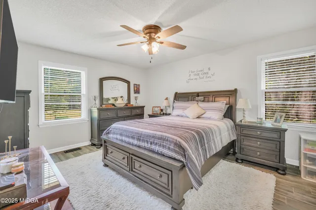 a bedroom with a bed and window