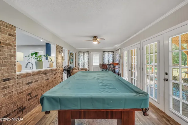 a bed sitting in a spacious bedroom next to a window
