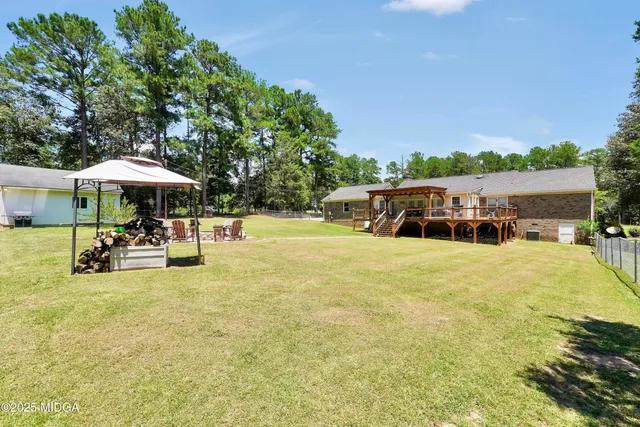 a view of swimming pool with table and chairs under an umbrella