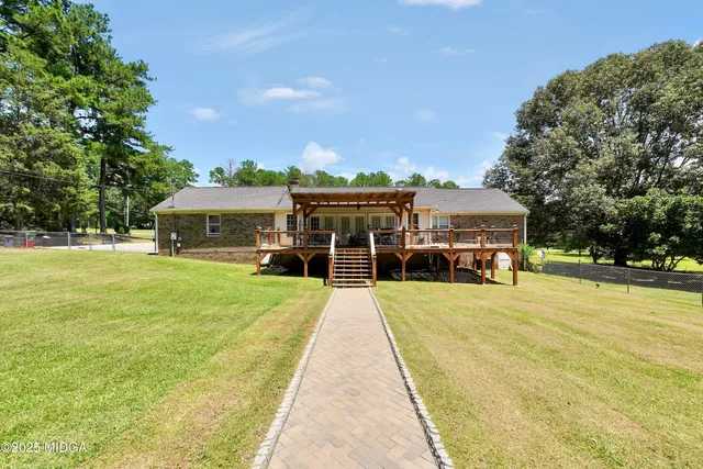 a view of house with outdoor space and swimming pool