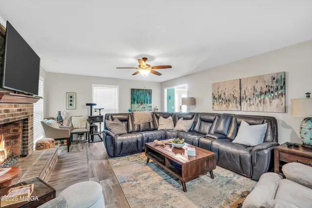a living room with furniture fireplace and a flat screen tv