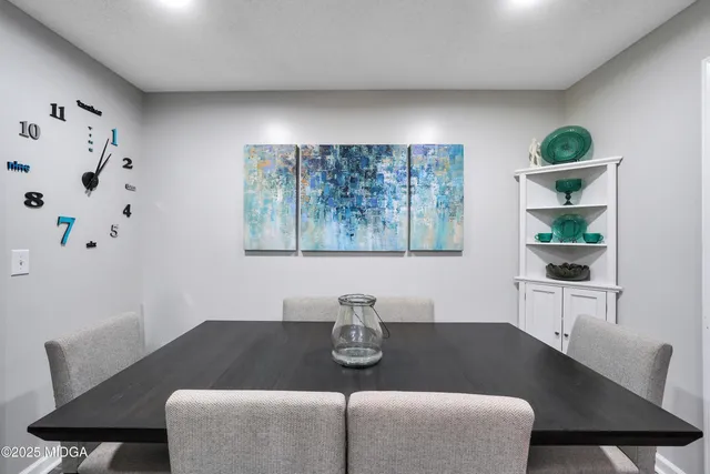 a view of a dining room with furniture and chandelier