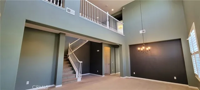a view of kitchen with refrigerator and dining table