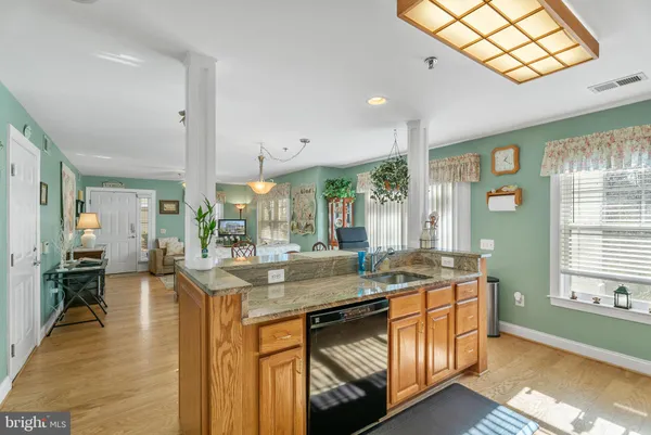 a kitchen with stainless steel appliances granite countertop a sink and cabinets