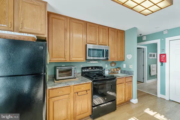 a kitchen with stainless steel appliances a stove a microwave and sink