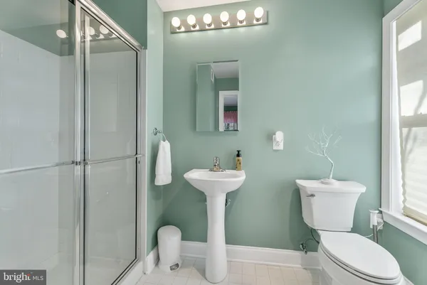 a bathroom with a toilet a sink and a mirror