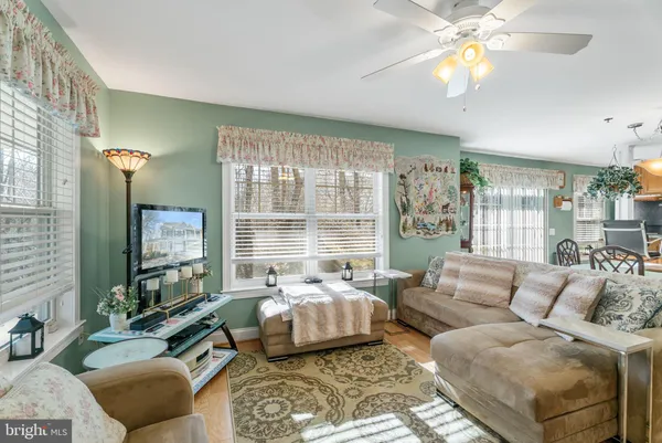 a bedroom with furniture and a large window