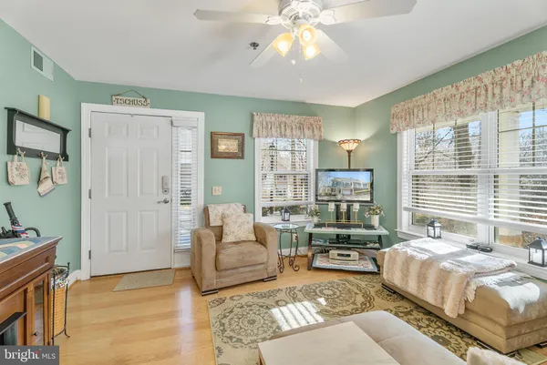 a spacious bedroom with a bed a couch and a chandelier