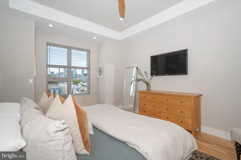 a bedroom with a bed and a flat screen tv