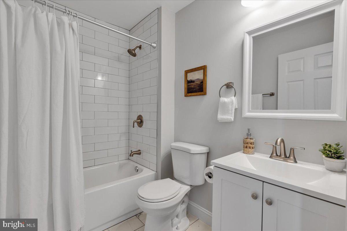 3908 Rokeby Road Baltimore, MD 21229 - Photo 15 of 28 a bathroom with a sink toilet and shower