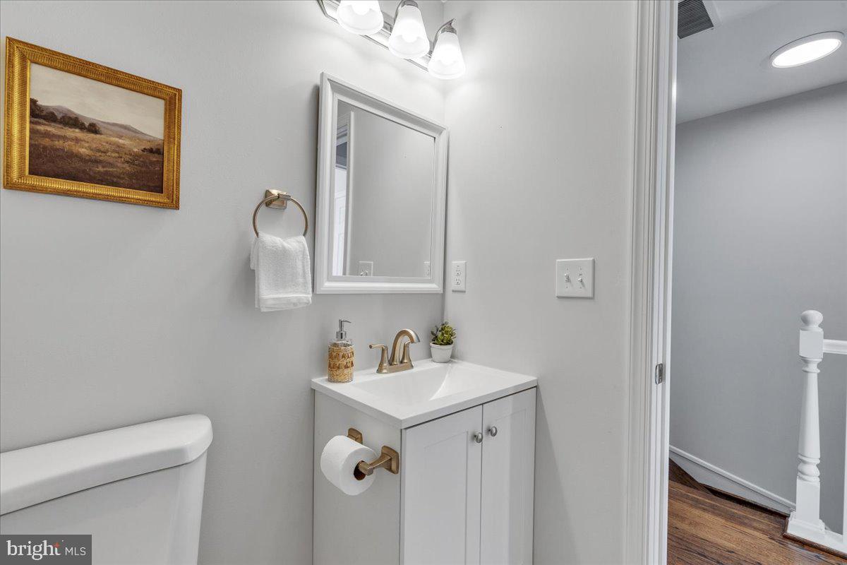 3908 Rokeby Road Baltimore, MD 21229 - Photo 16 of 28 a bathroom with a sink mirror and toilet