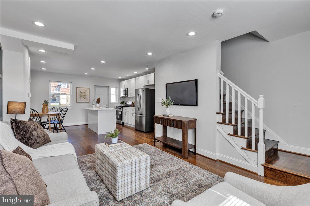 3908 Rokeby Road Baltimore, MD 21229 - Photo 2 of 28 a living room with furniture and a flat screen tv