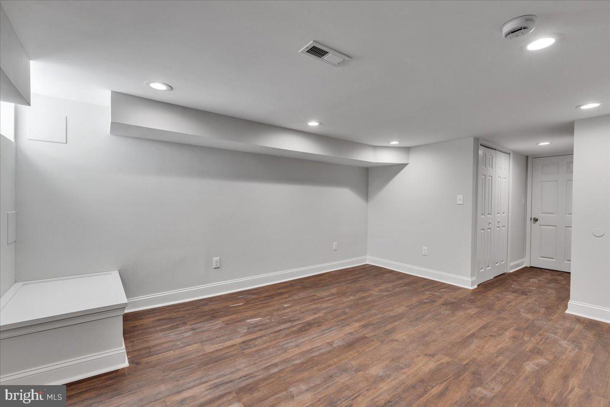 3908 Rokeby Road Baltimore, MD 21229 - Photo 21 of 28 a view of an empty room with wooden floor and a toilet