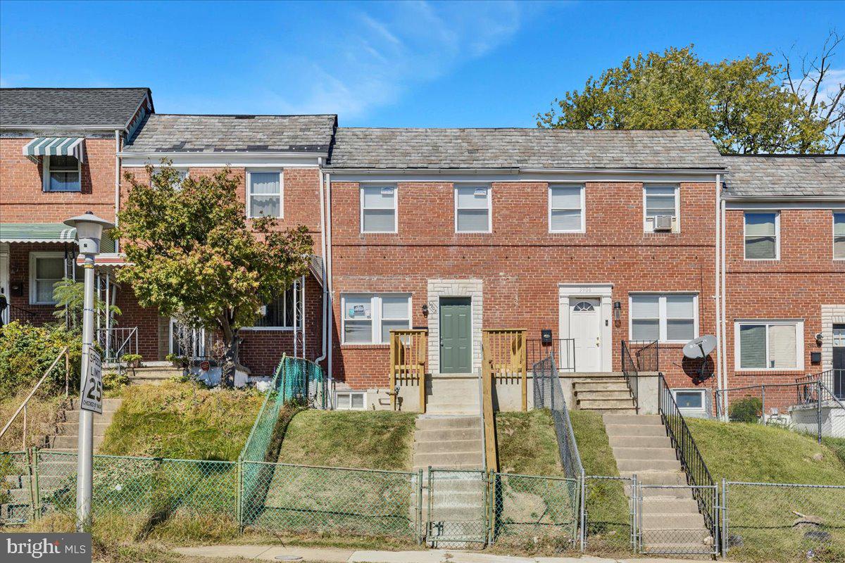 3908 Rokeby Road Baltimore, MD 21229 - Photo 27 of 28 a view of a yard in front of a brick house