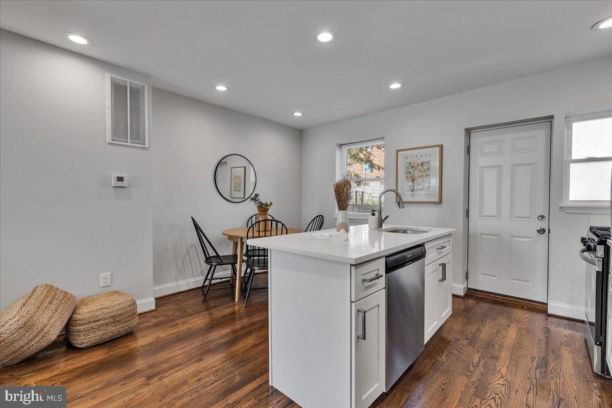 3908 Rokeby Road Baltimore, MD 21229 - Photo 7 of 28 a kitchen with stainless steel appliances granite countertop a sink and a wooden floors