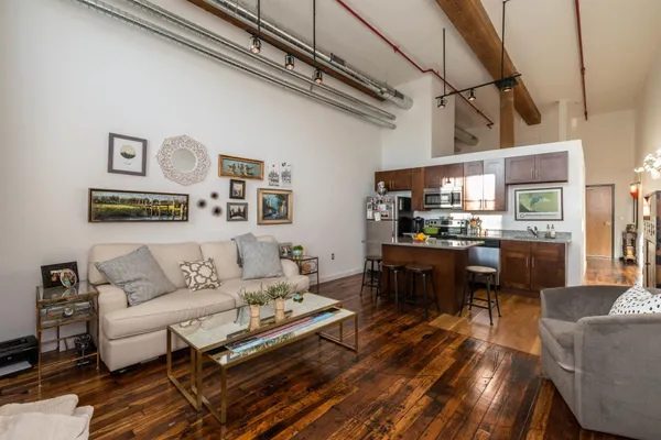 a living room with furniture and kitchen view