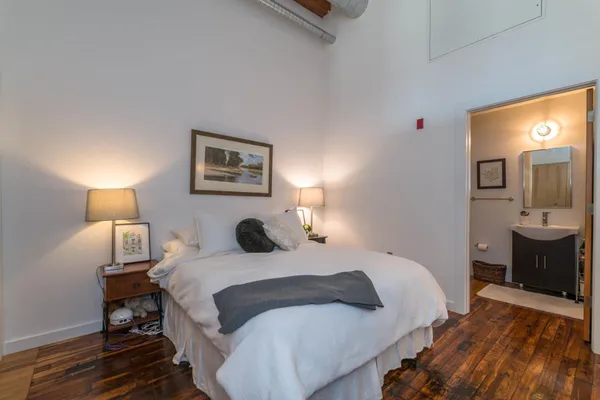 a bedroom with a bed and a lamp