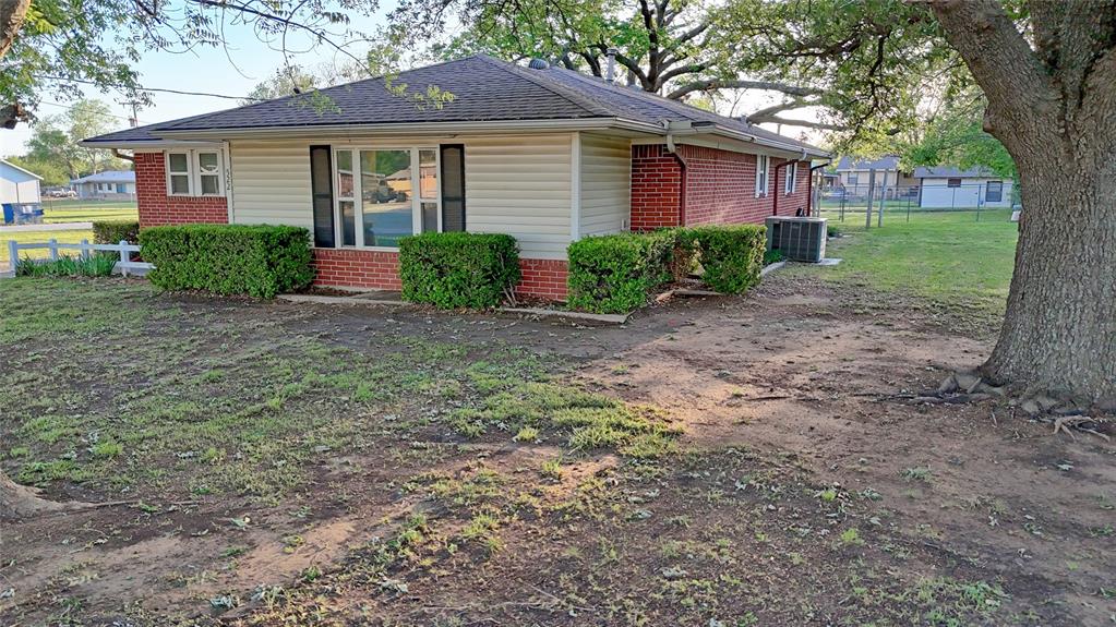 522 Montague Street Nocona, TX 76255 - Photo 13 of 25 a front view of a house with garden