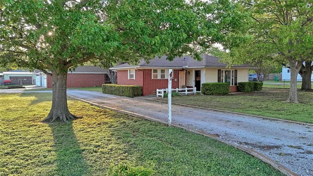 a front view of house with yard and green space